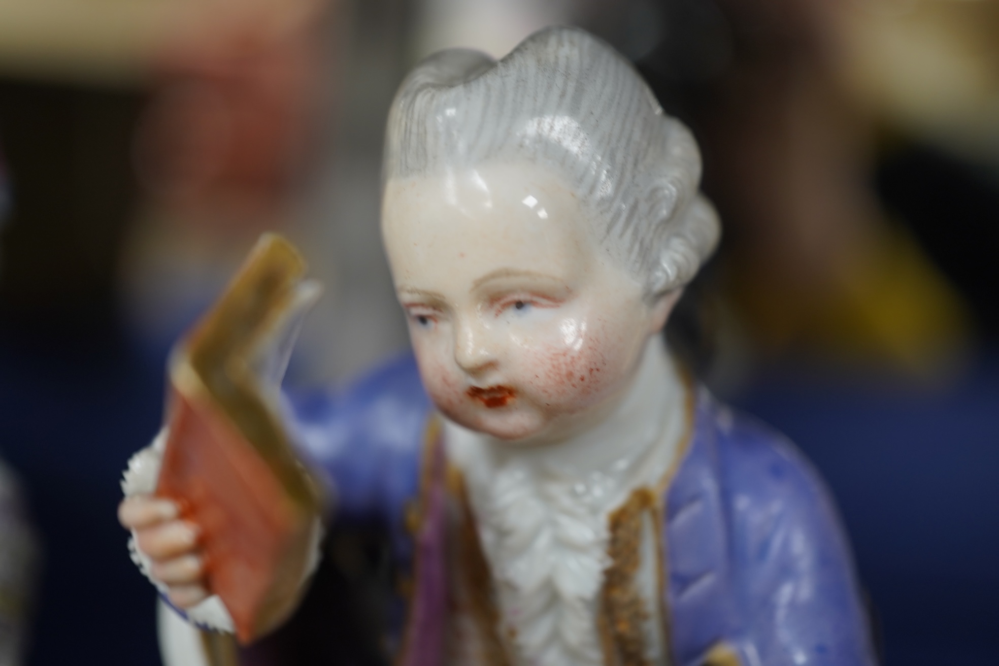A pair of 19th century Meissen figures of a girl holding a shell and a boy holding a book, in size model number 628, tallest 13cm